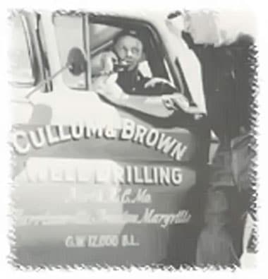 john brown talking on the phone in his car