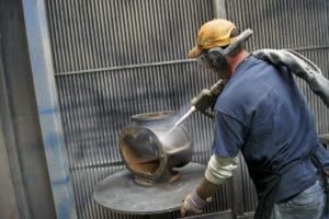 worker remanufacturing a compressed air system